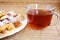 Teatime: close-up cup of tea and cookies on plate