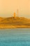 Technical building and metal tower on a hill on the coast. Iceland fjords. Toned