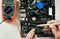 A technician checks the serviceability of motherboard