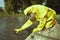 Technician in chemical protective suit collecting water contamination samples