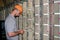 The technician connects the wires to the patch panel of the server room of the data center. The engineer works with the telephone