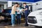 Technician And Couple Examining Metallic Alloy