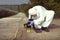 Technician Criminologist photographing tire print left in dust of field way