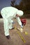 Technician Criminologist preparing tire print left in dust of field way for documentation