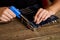 Technician or engineer is focused on repairing circuit board with soldering iron.