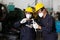 Technician or factory worker wearing face mask for protect virus, looking spring and measures a metal in factory