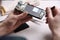 Technician fixing mobile phone at table, closeup.