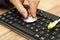 Technician hand is holding a stethoscope over computer keyboard