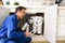 Technician installing reverse osmosis equipment under the sink