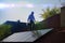 Technician installs solar panels on the roof