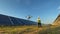 Technician and investor using infrared drone technology to inspect solar panels and wind turbines in solar cell farm