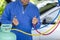 Technician man check car air conditioning system refrigerant recharge, Repairman holding monitor tool to check and fixed car air