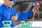 Technician man check car air conditioning system refrigerant recharge, Repairman holding monitor tool to check and fixed car air