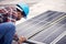 Technician, measuring tape and solar panel on rooftop for check, planning or renewable energy project. Black man