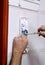 Technician placing the new intercom phone inside the home