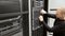 IT technician removes harddrive from blade server in datacenter