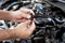 Technician Removing the gasoline injector part in engine room check dust and test pressure in process