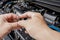 Technician Removing the gasoline injector part in engine room check hole on part dust and test pressure