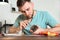 Technician repairing mobile phone at table