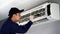 Technician service cleaning air conditioner indoors