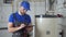 Technician servicing an hot-water heater. Man check equipment of the boiler-house - thermometer.