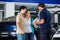 Technician Showing Metallic Hubcap To Couple