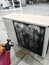 A technician spraying a chemical substance on air conditioner compressor using water dispenser pump.