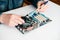 Technician using brush for computer cleaning, clean the motherboard