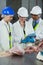 Technician using digital tablet while examining meat