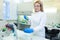 Technician using laboratory pipette and loading samples to a centrifuge machine in a medical or scientific laboratory