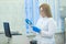 Technician using laboratory pipette and loading samples to a centrifuge machine in a medical or scientific laboratory