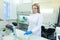 Technician using laboratory pipette and loading samples to a centrifuge machine in a medical or scientific laboratory