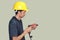 Technician with yellow helmet standing and driller in hand on clear background. clipping path