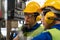 Technicians and engineers are talking in an industrial facility. Technicians are checking the operation of the old machine via the