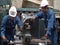 Technicians and engineers are working on machines in a factory. Twins caucasian man mechanical engineer checking equipment in the