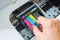 Technicians are install setup the ink cartridge of a inkjet printer the device of office automate