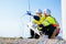 Technicians team with safety uniform working at wind turbine field
