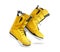 Technological yellow snowboard boots on white background