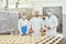 Technologist and baker inspect the bread production line at the bakery