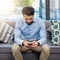 Technology allows for the office to be held in hand. a young businessman texting on a cellphone in an office.