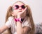 Technology for children: a girl wearing pink glasses uses a smartwatch