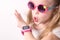 Technology for children: a girl wearing pink glasses uses a smartwatch.