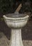 Technology: Close up of a bronze sundial on a carved stone pedestal. 1