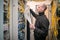 Technology Concept. A man works with communication cables in a data center. A technician stacks a wiring harness in a server room