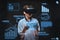 Technology concept. Teenager dressed in a white t-shirt using virtual reality glasses with graph charts, numbers, lines