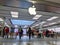 Technology crazed customers shopping inside an Apple store, scoping out iPhones and