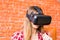 Technology, gaming, entertainment and people concept - young woman with virtual reality headset, controller gamepad