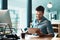 Technology helps him perform his best. a young businessman using a digital tablet at his desk in a modern office.