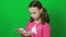 Technology and internet concept - little student girl with smartphone