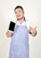 Technology merchant Asian fat man in white and blue apron is Moody presents some data in tablet when get good news from connectio